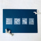 a flat display of four translucent knoten sea stamp-style stickers on a dark blue envelope 