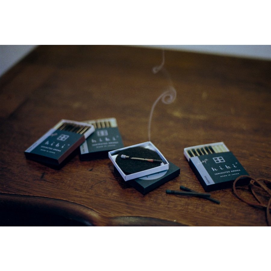 several hibi deep series incense matches placing on the table, one of them is burning on the pad