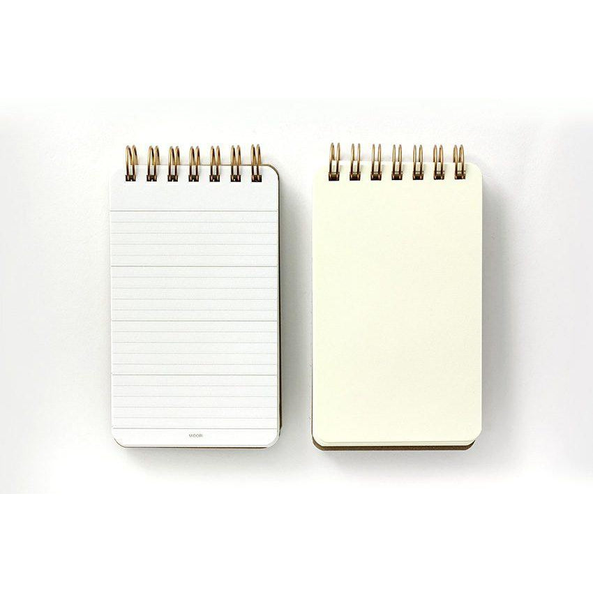 portrait view of two midori grain notepads side by sides, showing two different inner pages: lined and blank