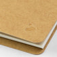 detail view of the swan logo on the kraft paper cover